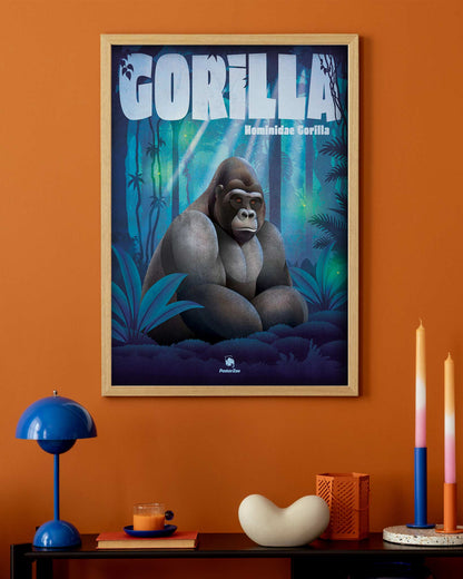 Ein illustriertes Tier-Plakat mit einem sitzenden Gorilla in einer nächtlichen Wald-Szenerie, hängt an einer Wand in einem orangenen Wohnzimmer mit moderner Einrichtung.